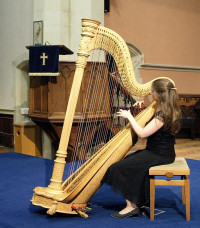 Laurette playing a harp recital in Bristol